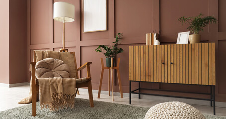 Interior of stylish living room with wooden armchair and commode