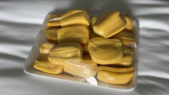 jackfruit breadfruit on bed disposable container hand takes fruit. High quality 4k footage