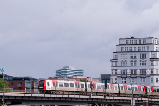 Modern S Bahn train crossing bridge in Hamburg Germany, public transport detail with sustainable mobility infrastructure, perspective of tracks and ecofriendly travel background concept