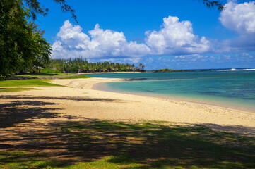 Clear turquoise water and white sandy shoreline at St. Felix Public Beach in southern Mauritius.