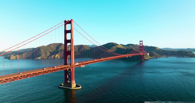 Aerial view of the Golden Gate Bridge spanning across the water with mountains in the background, San Francisco, California, United States.
