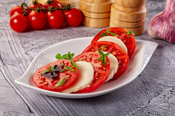 Italian caprese salad with mozzarella, tomato and basil
