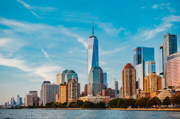 Manhattan skyline with One World Trade Center view. Manhattan skyline with One World Trade Center under a clear blue sky, showcasing vibrant urban life.