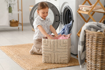 Little girl doing laundry at home