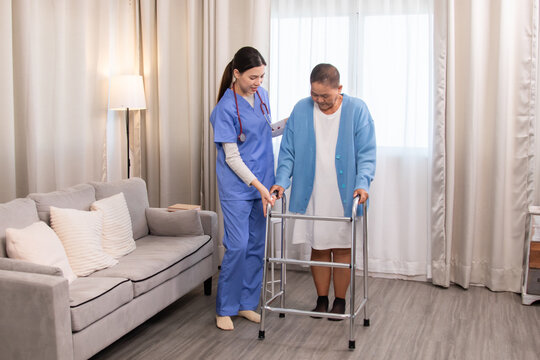 Young nurse assisting senior woman in walking with a walker, demonstrating caregiving, encouragement, and physical rehabilitation at home, healthcare, caregiver, medical, hospitality, recover.