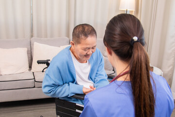 Elderly, caregiver, nurse, patient, support focus on gentle hand massage therapy at home; physiotherapy guidance eases arthritis pain, boosts joint movement, builds trust communication, promotes aging