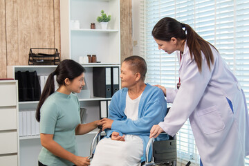 Fototapeta premium Senior woman in wheelchair receiving supportive visit from younger family member while doctor observes, symbolizing care, connection, and emotional bonding in medical environment, healthcare.