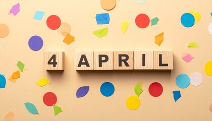 Wooden Blocks with Date 4 April. Calendar for birthday or anniversary on solid colored background with confetti
