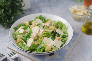 A bowl with classic Caesar salad	