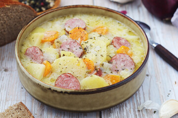 A bowl with traditional German potato soup with sausages