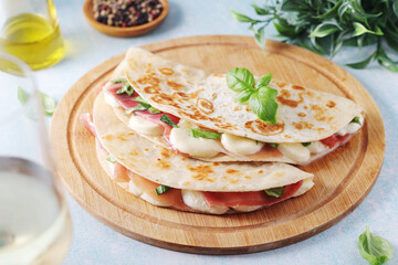 Traditional Italian dish Piadina romagnola - flat bread with mozarella and proscuitto