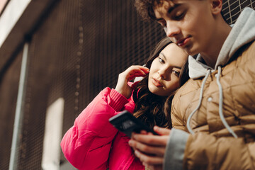 Young couple using phone and sharing content on social media