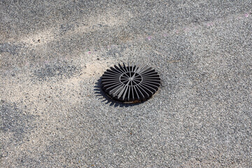 Rainwater Drain Grate on a Flat Roof with Bituminous Membrane and Gravel Covering