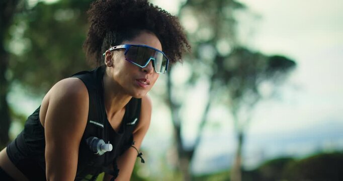 Tired, runner and breathing with woman in nature for workout break, cardio fatigue and fitness. Exercise rest stop, training challenge and exhausted with person in forest for endurance and athlete