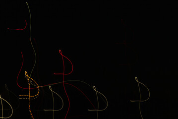 Abstract light trails of stars in night sky during long exposure near lunar eclipse