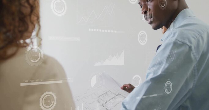 Standing male architect holding rolled blueprint in studio, with digital chart overlays, copy space - Powered by Adobe