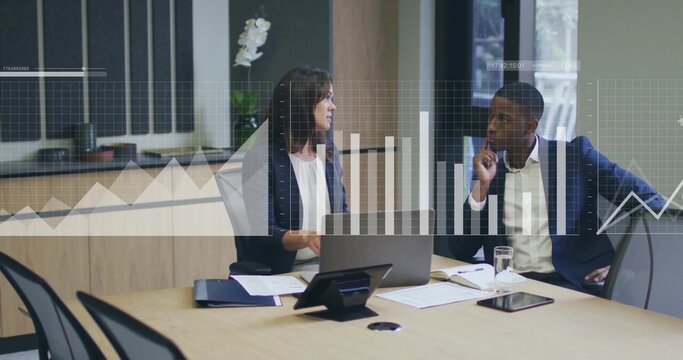 Colleagues in suits reviewing bar-line charts in office with laptop, tablet, documents, phone - Powered by Adobe