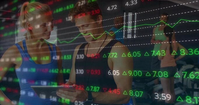 Examining tablet tracking performance trainer and client in gym studio, market charts overlay - Powered by Adobe