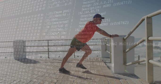 Leaning man wearing tee stretching calf on boardwalk railing by ocean with code overlay, copy space - Powered by Adobe