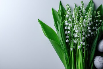 Obraz premium Delicate lily-of-the-valley bouquet with eggs on a light background