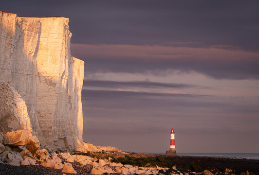 Beachy head lighthouse at low tide during sunset south downs east Sussex south east England UK