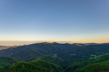 clean minimalist mountain view with rolling hills and clear sunset sky. nature background with empty space 