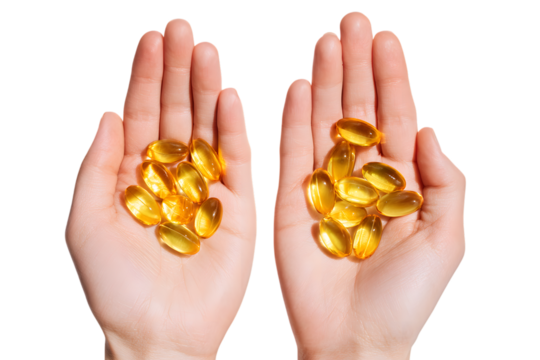 Healthy omega 3 supplements.  Close up of hands holding fish oil capsules.