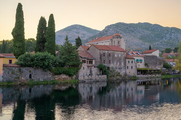 Obraz premium Historical architecture reflects in serene waters of Trebinje at twilight