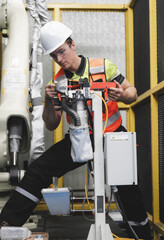 Smart Caucasian engineer work setup AI automated in robotics electronics engineering laboratory. Technician inspector maintenance repair check robot arm machine in artificial intelligent laboratory.