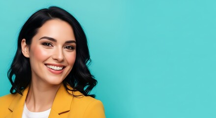 Fototapeta premium A smiling woman with dark hair and a yellow blazer against a teal background.