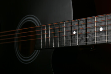 Fototapeta premium Modern guitar on dark background, closeup