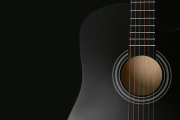 Fototapeta premium Modern guitar on black background, closeup