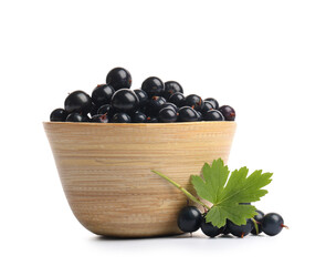 Wooden bowl with fresh black currants on white background