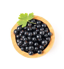 Wooden bowl with fresh black currants on white background
