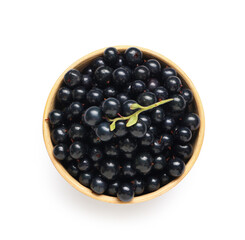 Wooden bowl with fresh black currants on white background