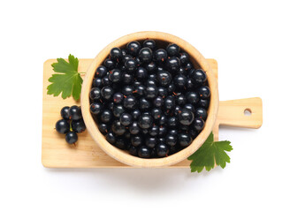 Wooden bowl and board with fresh black currants on white background