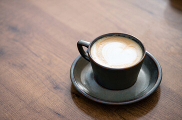 Creamy Latte with Heart Art in Ceramic Cup on Wooden Table