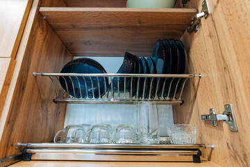 A welldesigned kitchen cabinet can hold an organized collection of plates, glasses, and a variety of other essential kitchenware, making it a crucial functional part of the home setting