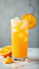 Fototapeta premium Iced orange juice with orange slices in tall glass on marble , summer, ice