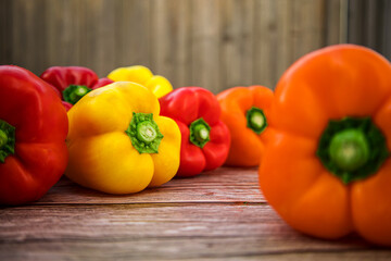 Assortment of bell peppers on rustic wooden background