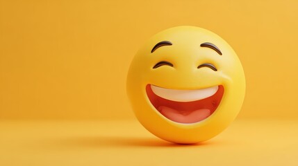 Fototapeta premium Close-up of a smiling laughing emoji ball with a cheerful expression on a vibrant yellow background for fun and happiness imagery