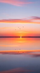 sunset over a mirror-like salt lake, pastel pink and orange sky reflecting perfectly on the water, minimal silhouettes of birds flying, cinematic aesthetic