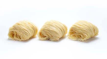 Three bunches of dried noodles on white background