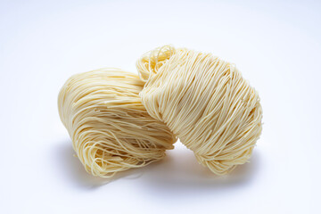 Two bunches of dried noodles on white background