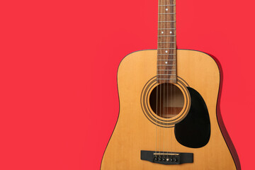 Modern guitar on red background, closeup