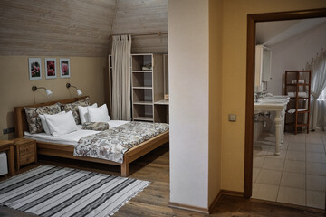 Cozy bedroom interior with a view to a bathroom.