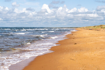 The stunning beach view in Southern Sweden and charming coastal town under a beautiful cloudy sky, Bastad, Sweden