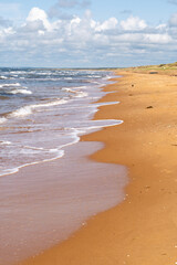 The stunning beach view in Southern Sweden and charming coastal town under a beautiful cloudy sky, Bastad, Sweden