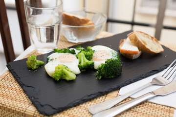 breakfast of crumpled eggs with broccoli