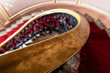 Close-up of a polished gold colored stair rail, classic architecture details